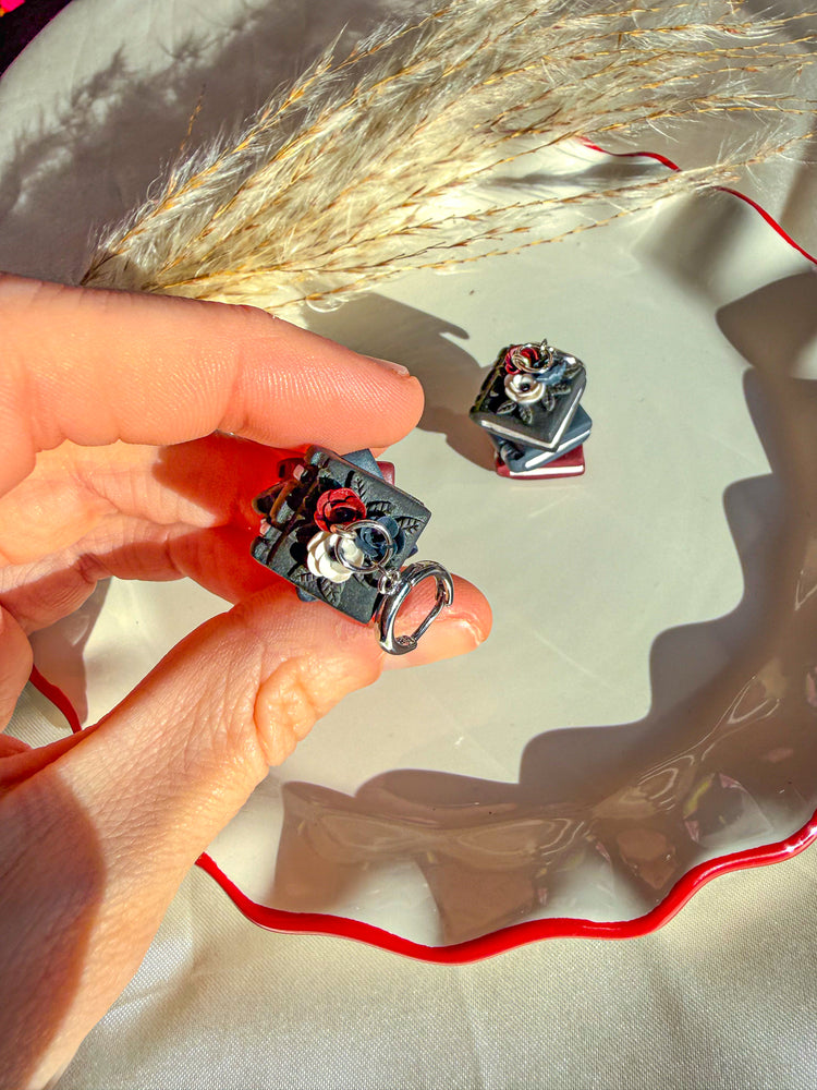 Black book dangle earrings with dark accent flowers on top