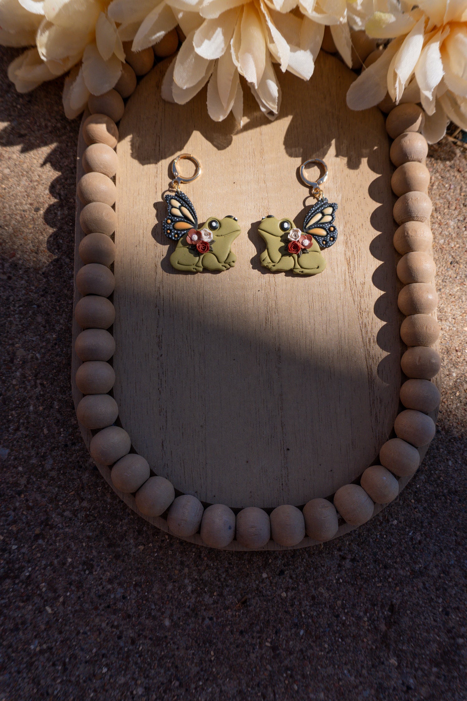 Butterfly wings attached to frogs, as earrings