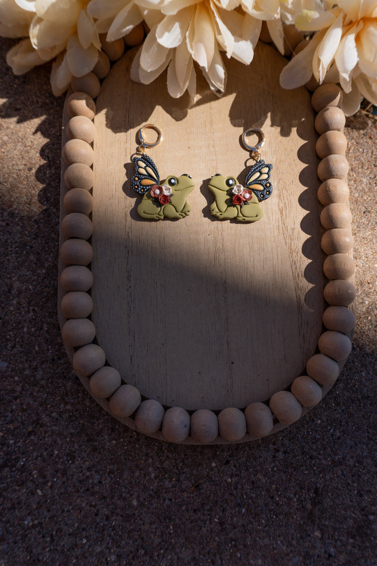 Butterfly wings attached to frogs, as earrings