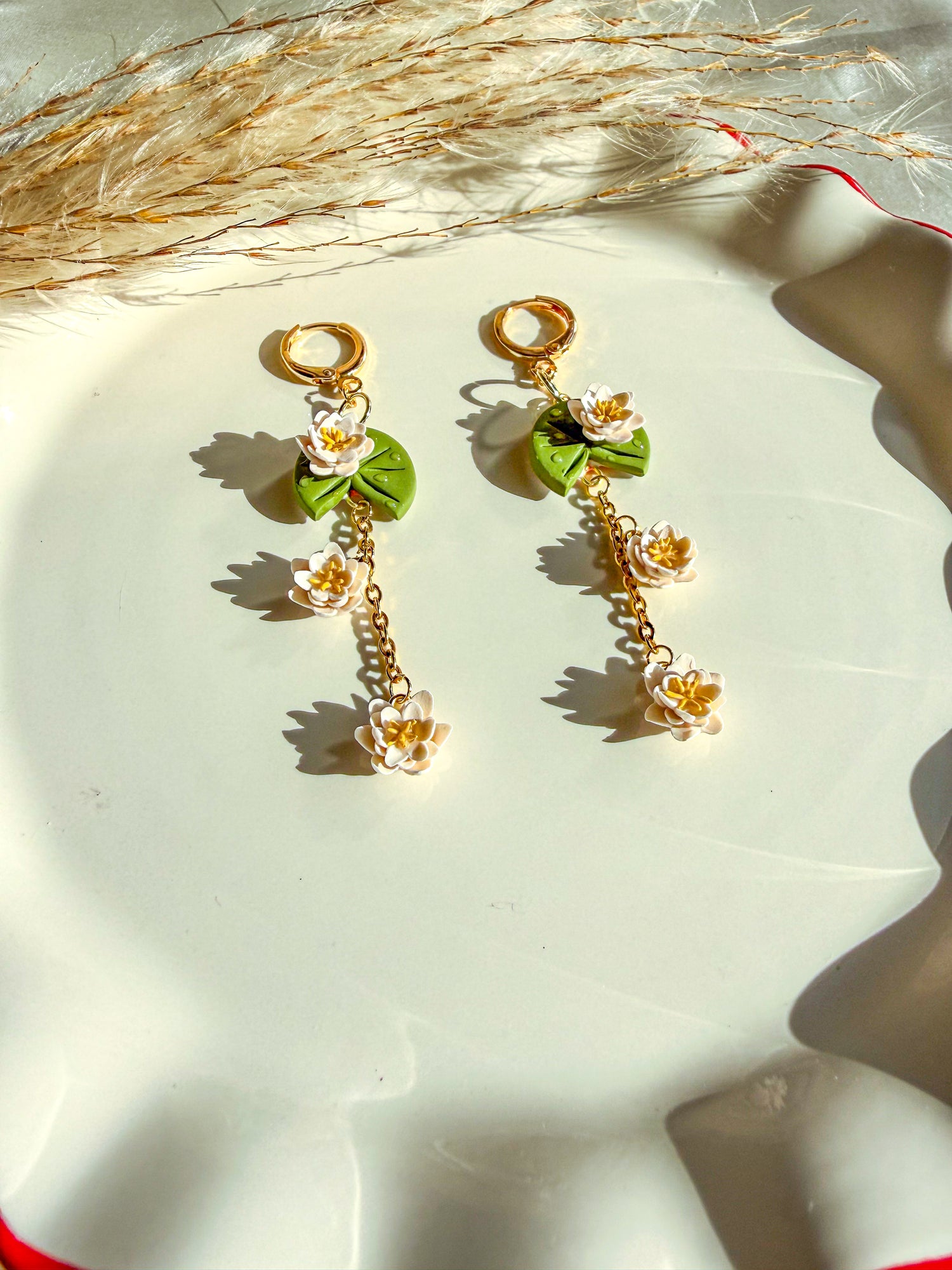 handmade lily pad flower earrings with white blossom flowers