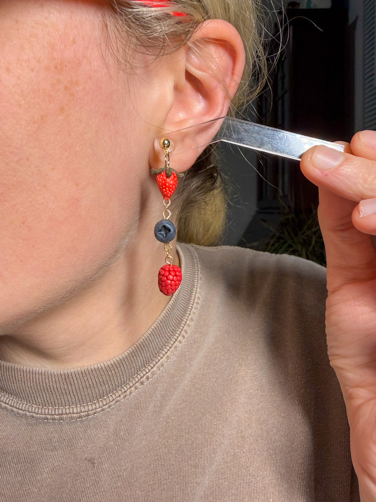 Try on stawberry, blueberry and raspberry earrings dangling with gold filled earring post