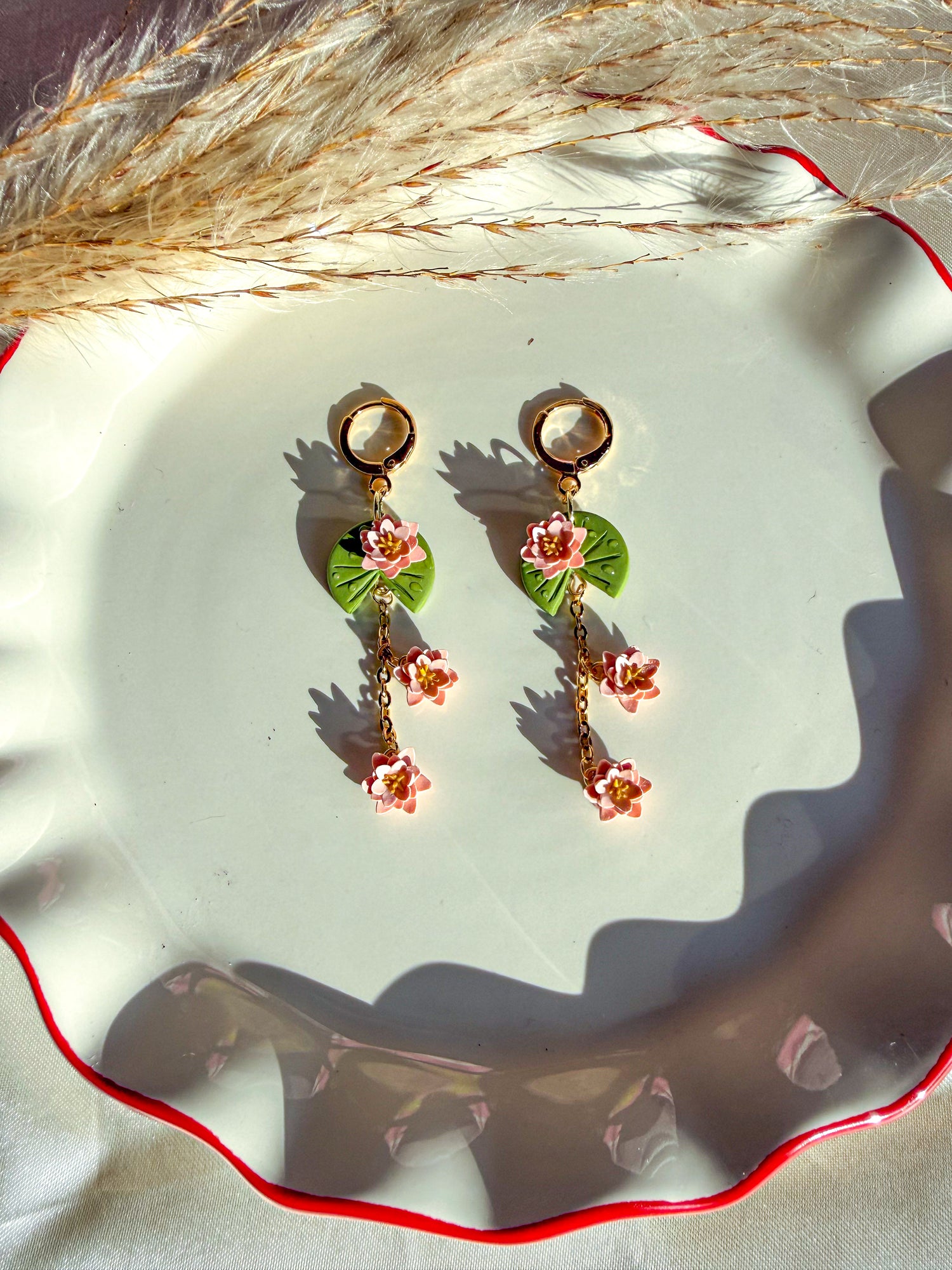 Pair of lily pad and pink lily flowers on drop earrings