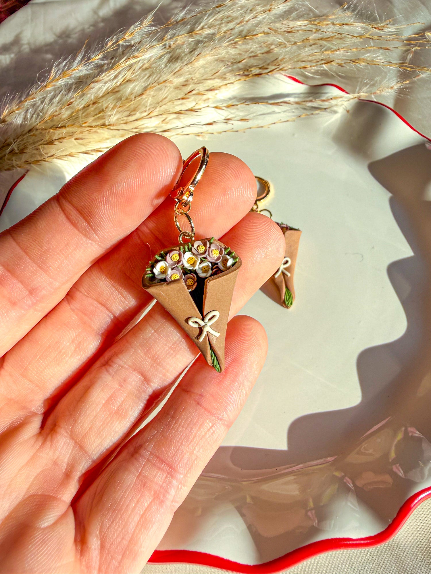 White and lilac colored  daisy flowers with green flower stems in flower bouquet earring