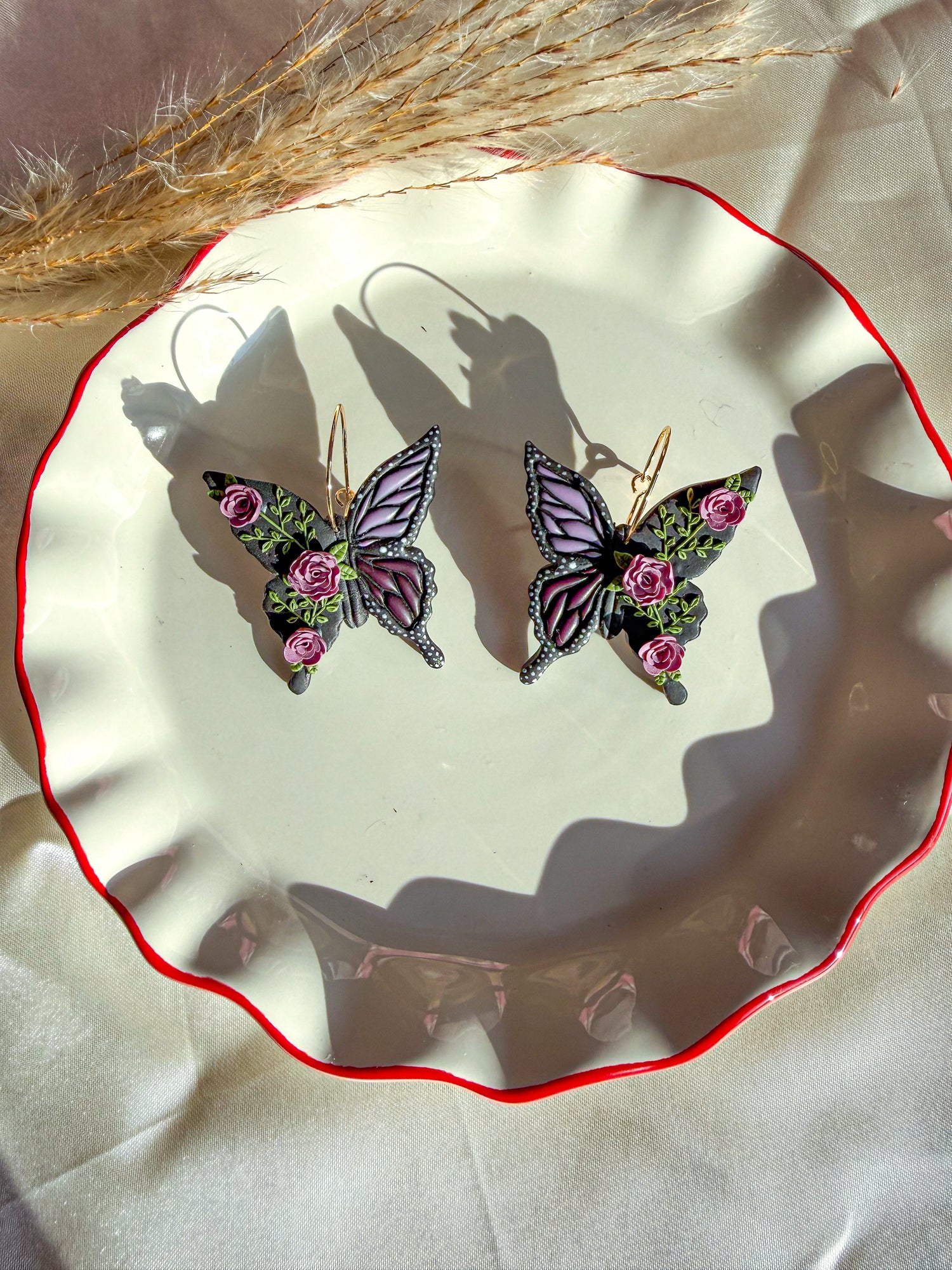 Butterfly hoop earrings with purple roses and accents