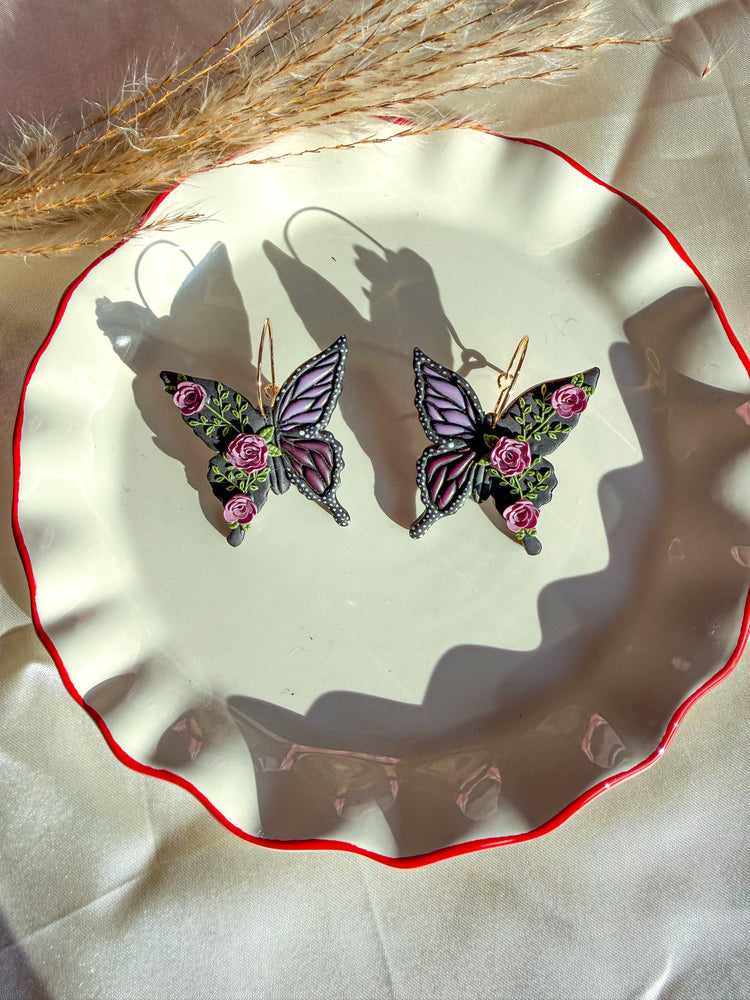 Butterfly hoop earrings with purple roses and accents