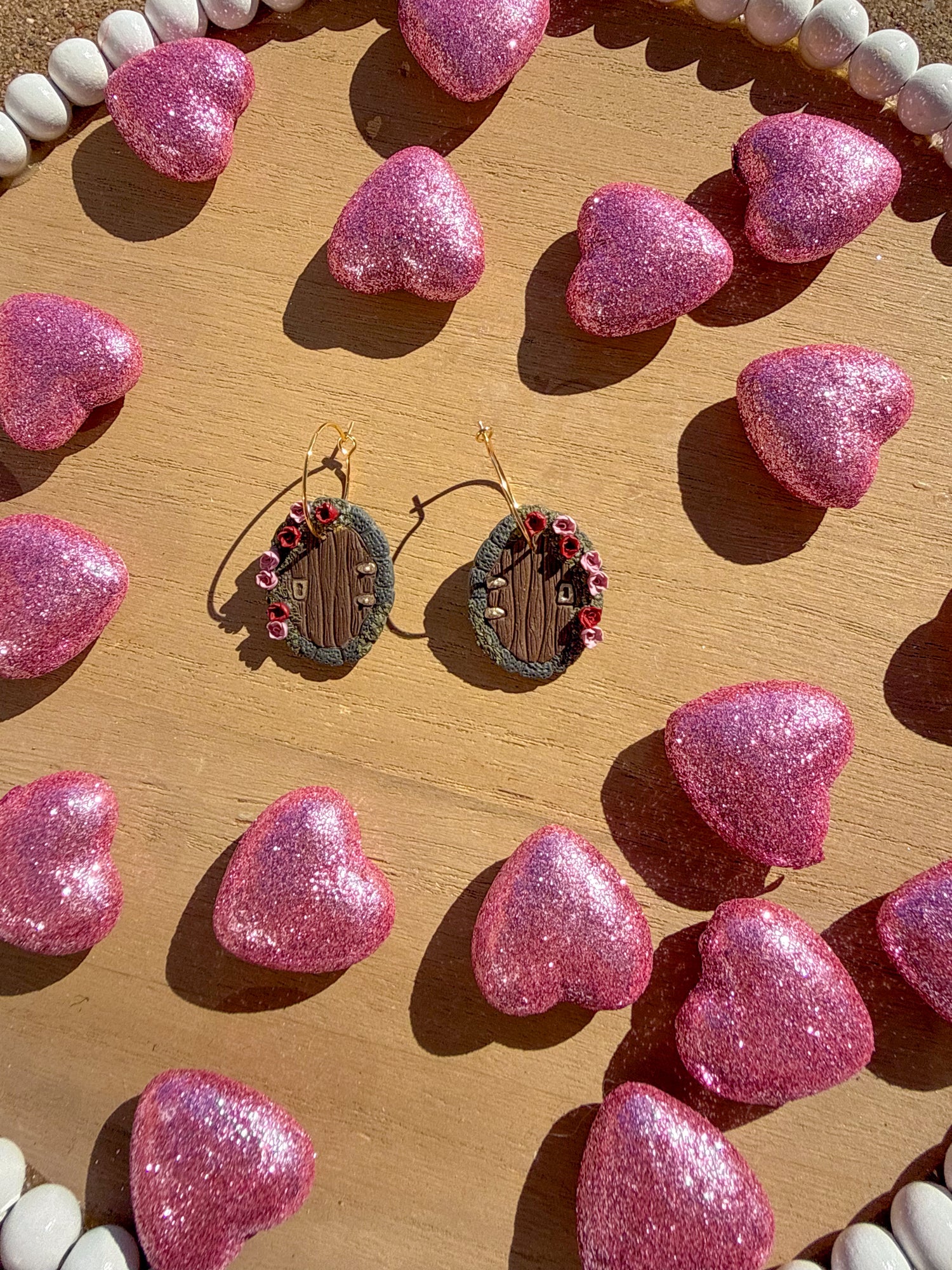 brown hobbit doors with red and pink roses