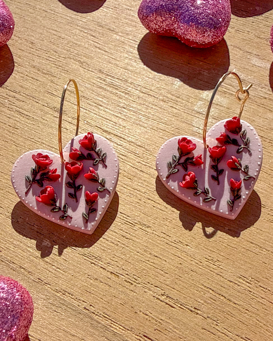 Polymer clay red rose stem flowers earrings on a pink shaped heart